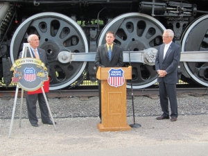 Omaha Mayor Jim Suttle (left) and Union Pacific's senior vice president - Corporate Relations Bob Turner (right) listen as Joe Gudenrath, Omaha Downtown Improvement District, executive director explains what Union Pacific Railroad means to downtown Omaha, during the Train Town USA ceremony.